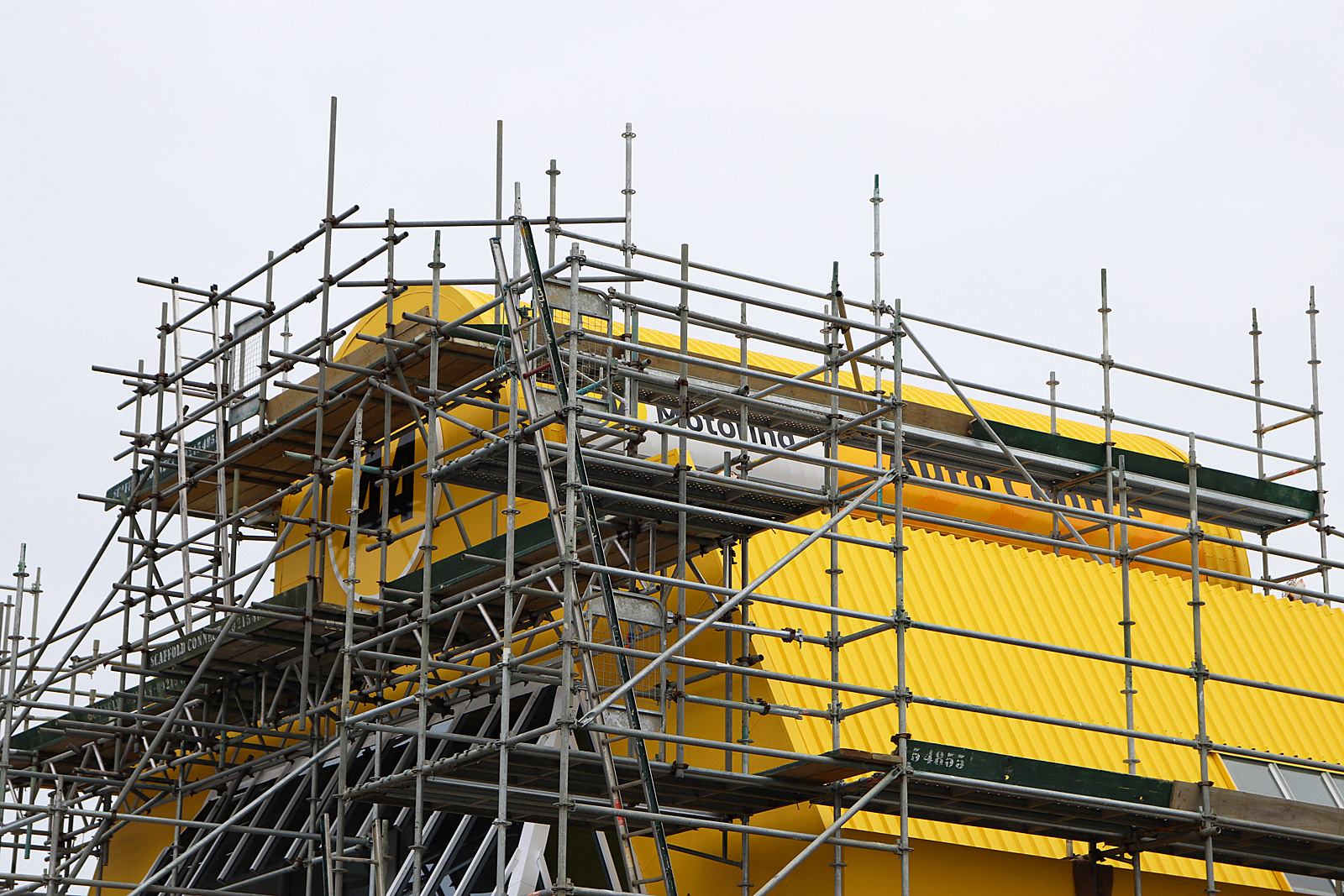 AA Manukau - installatioin of 2 metre circular panel and 3d lettering